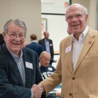 Happy Fox and Larry Robson shaking hands